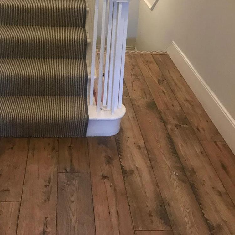 Carpet up stairs with laminate floor in hallway